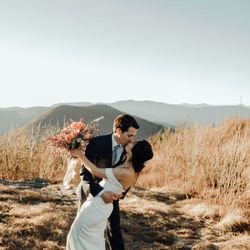 Asheville Luxury Elopement - Recently married couple on mountain top for their adventure elopement.