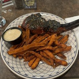 Bone- in pork chop with sweet potato fries Bone- in pork chop with sweet potato fries