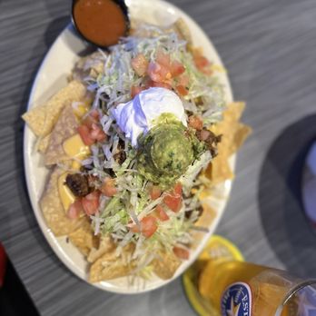 Flying Pug - Small nachos. Yes you read right, SMALL!!! - Sports Bars Near Me - Spring, Texas
