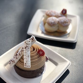 Moulin - two desserts on plates on a table - Cafes Near Me - Laguna Beach, California Moulin - two desserts on plates on a table - Cafes Near Me - Laguna Beach, California