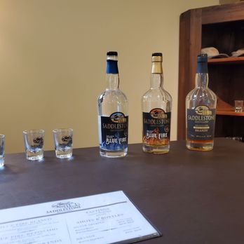 Equus Run Vineyards - bottles of alcohol on a table - Venues & Event Spaces Near Me - Midway, Kentucky