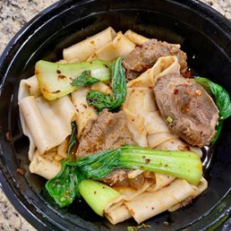 Spicy Beef Hand-Ripped Noodle - sliced braised beef on top of hand ripped noodles with chili oil and bok choy