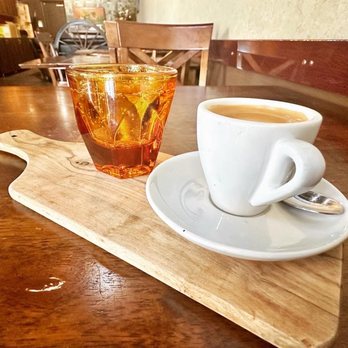 Cuppa Austin - a cup of coffee and a spoon on a table - Coffee & Tea Near Me - Austin, Texas