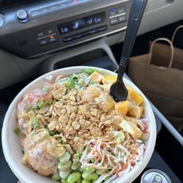 Poke Bowl Pick 2 (salmon and spicy tuna) with crab meat salad, edamame, mango, seaweed salad, and garlic crisps. Poke Bowl Pick 2 (salmon and spicy tuna) with crab meat salad, edamame, mango, seaweed salad, and garlic crisps.