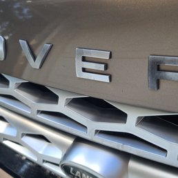 The black marks on the letters are the damage. This is "ROVER" The black marks on the letters are the damage. This is "ROVER"