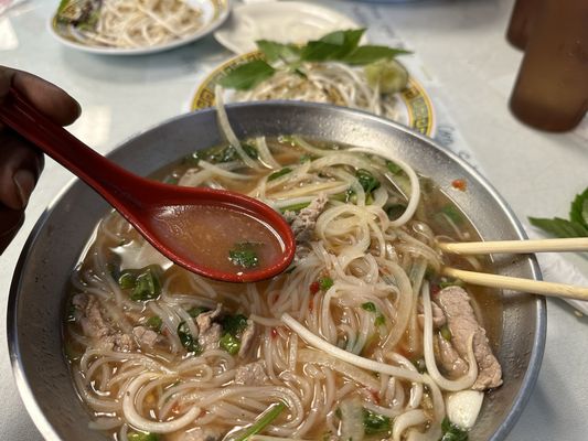 Photo of Vietnam Kitchen - Louisville, KY, US. B1. Pho Tai : Beef Pho with onions, rice noodles, sliced beef, green onions, mint and cilantro