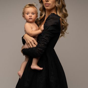 Portraits by Lisa Ann - Minimalist studio motherhood photo with a mom in black holding her baby - Session Photography Near Me - Davie, Florida Portraits by Lisa Ann - Minimalist studio motherhood photo with a mom in black holding her baby - Session Photography Near Me - Davie, Florida
