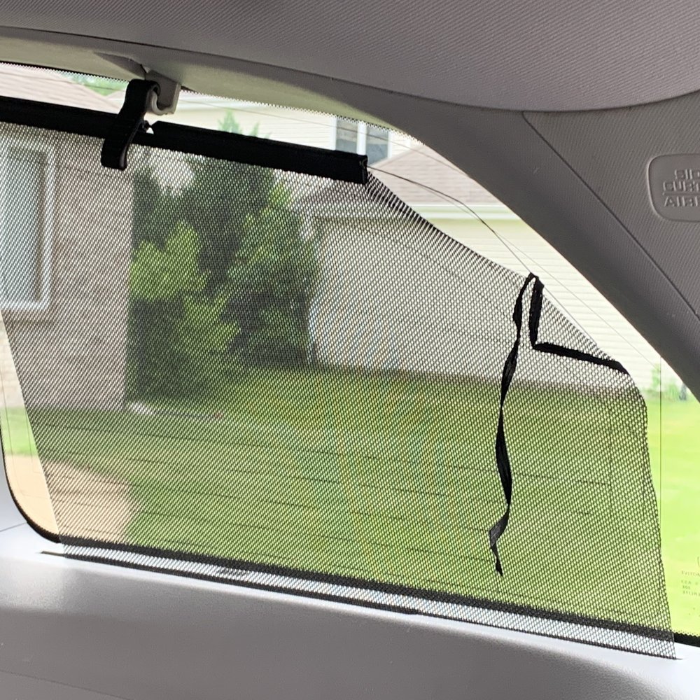 Shredded passenger side, rear window shade.