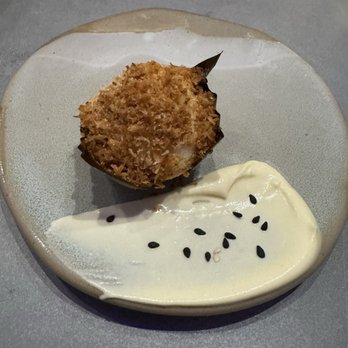 Kaya - Bibingka rice cake in banana leaf topped with sweetened burnt coconut, salted egg duck mousse, coconut caramel - Filipino Near Me - Orlando, Florida