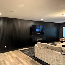 Ace Handyman Services Greater Triangle and Johnston County - Black slat accent wall with wall-mounted TV in Wake Forest, NC