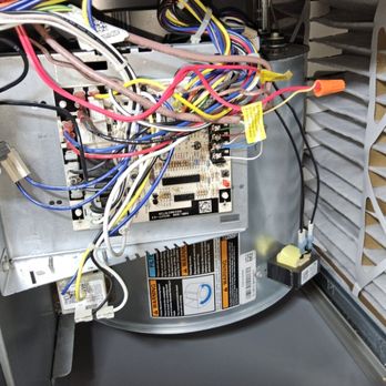 Conley Cooling and Heating - Looking inside a gas furnace at the blower compartment - Heating & Air Conditioning/HVAC Near Me