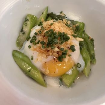 Au Courant - First course: the perfect pouched egg with asparagus and potato crumble. - Modern European Near Me - Omaha, Nebraska
