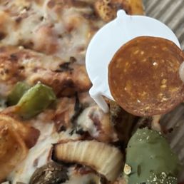 Pieces of pepperoni in our vegetarian pizza
