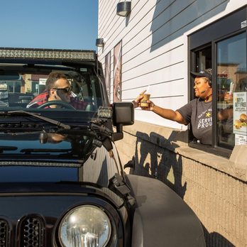 Hardee's - a man holding a beer in front of a jeep - Burgers Near Me - Orange City, Iowa Hardee's - a man holding a beer in front of a jeep - Burgers Near Me - Orange City, Iowa