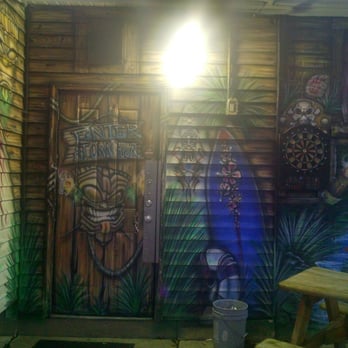Big and Rich Bar - a wooden door with a tiki mask painted on it - Bars Near Me - Green Bay, Wisconsin Big and Rich Bar - a wooden door with a tiki mask painted on it - Bars Near Me - Green Bay, Wisconsin