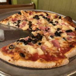 Ham, pineapple, black olive pizza