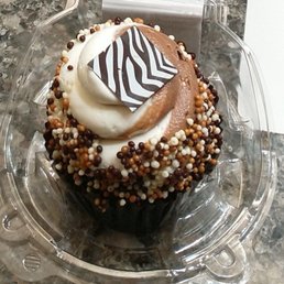 Chocolate cupcake with pudding in the middle. Amazing icing and little round crunchies Chocolate cupcake with pudding in the middle. Amazing icing and little round crunchies
