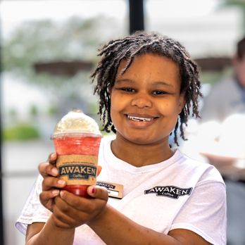 Awaken Coffee - a young girl holding a cup of ice cream - Coffee & Tea Near Me - Greenville, North Carolina Awaken Coffee - a young girl holding a cup of ice cream - Coffee & Tea Near Me - Greenville, North Carolina