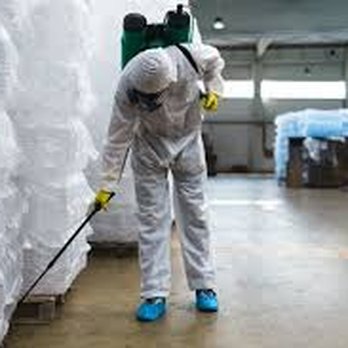 Lawn Buddys - a man in a protective suit with a mop - Lawn Services Near Me Lawn Buddys - a man in a protective suit with a mop - Lawn Services Near Me