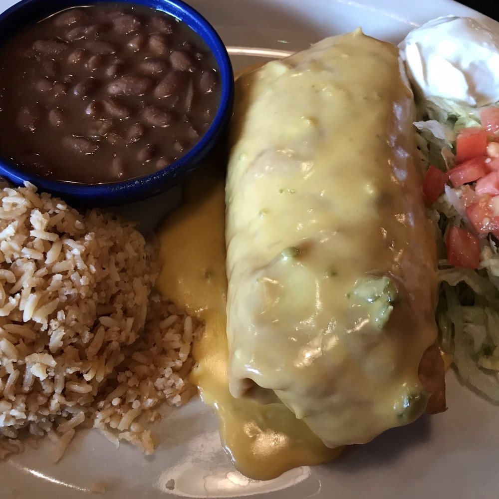 Beef Fried Chimichanga with Steak with a side of rice and beans. Beef Fried Chimichanga with Steak with a side of rice and beans.