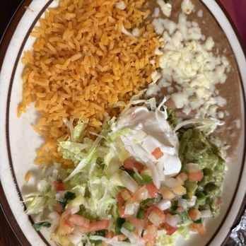Tequilas Mexican Grill - Spanish rice, refried beans, crema, pico degallo, and chopped lettuce for garnish on the fajitas. - Mexican Near Me - Burlington, Colorado Tequilas Mexican Grill - Spanish rice, refried beans, crema, pico degallo, and chopped lettuce for garnish on the fajitas. - Mexican Near Me - Burlington, Colorado