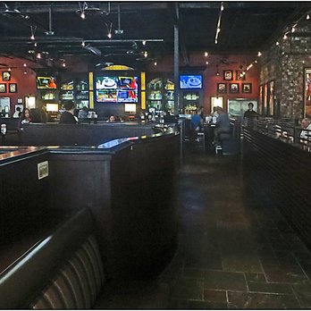 BJ's Restaurant & Brewhouse - Taken from hostess station. Large seating area on left. Bar ahead on left. Center isle. Smaller seating area on the right. - New American Near Me - Webster, Texas BJ's Restaurant & Brewhouse - Taken from hostess station. Large seating area on left. Bar ahead on left. Center isle. Smaller seating area on the right. - New American Near Me - Webster, Texas