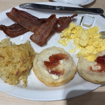The Toasted Yolk Cafe - Hash browns with cheese, biscuit, scrambled eggs, and bacon. Glass of orange juice. - Breakfast & Brunch Near Me - Johnson City, Tennessee