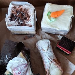 Tiramisu, carrot cake, strawberry cheesecake, cannoli, and rainbow cookie.