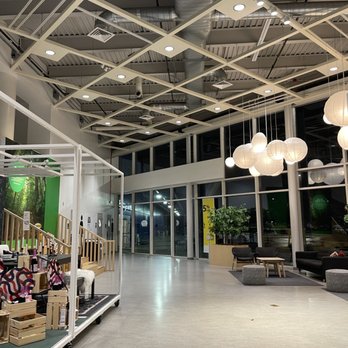 IKEA - A spacious IKEA store interior features seating arrangements, display shelves, and large windows, illuminated by ceiling lights and hanging paper lanterns. - Home Decor Near Me - Schaumburg, Illinois