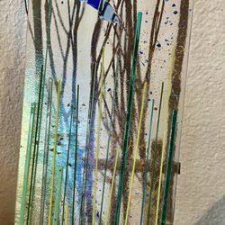 Aran's Art Studio - My "butterfly in water reeds" on display on a small wooden chair that was my mom's. The translucence is actually part of the glass.