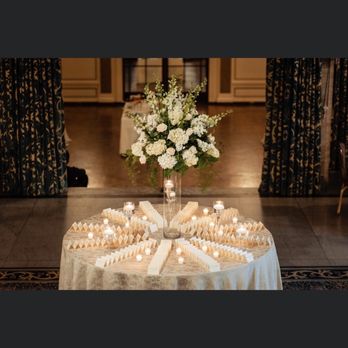 Whimsy - A round table decorated with a floral arrangement and numerous candles, likely for a wedding or celebration, in an elegant indoor setting. - Home & Garden Near Me - Greenville, Delaware