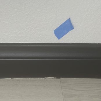 Gomez Pro Paint - Blue tape in a bedroom and paint on the floor - Painters Near Me