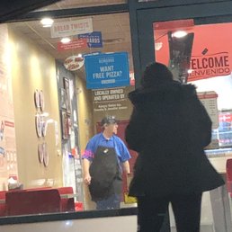 a woman walking in front of a restaurant