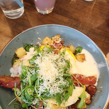 First Watch - The dish includes hardwood smoked bacon, house-roasted onions, sautéed spinach, and mozzarella cheese in a potato hash. - Breakfast & Brunch Near Me - Columbus, Ohio First Watch - The dish includes hardwood smoked bacon, house-roasted onions, sautéed spinach, and mozzarella cheese in a potato hash. - Breakfast & Brunch Near Me - Columbus, Ohio