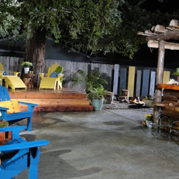 One Stop Landscaping - a patio with blue and yellow chairs - Landscaping Near Me One Stop Landscaping - a patio with blue and yellow chairs - Landscaping Near Me