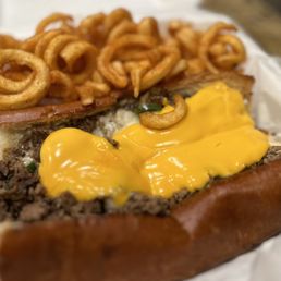 a hamburger with cheese and onion rings a hamburger with cheese and onion rings