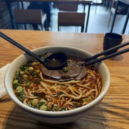 Flavorless beef noodle soup floating in chili oil. Flavorless beef noodle soup floating in chili oil.