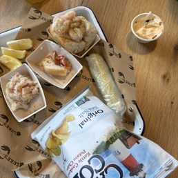 Half consumed Seafood Flight Gluten-Friendly Bun no butter for dairy free Half consumed Seafood Flight Gluten-Friendly Bun no butter for dairy free