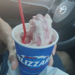 a hand holding a cup of ice cream a hand holding a cup of ice cream
