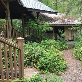 Rainier Cottages - Stairs lead to seating area on deck and path leads to hot tub. Covered hot tub! - Vacation Rentals Near Me
