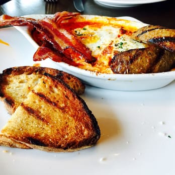 Amaro Bistro - Italian baked eggs with herb ricotta, Italian sausage, toast, and pancetta - Italian Near Me - Bothell, Washington Amaro Bistro - Italian baked eggs with herb ricotta, Italian sausage, toast, and pancetta - Italian Near Me - Bothell, Washington