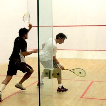 Play Squash Academy - Academy Director Jay(white) in action against coach Shahid - Sports Clubs Near Me - McLean, Virginia