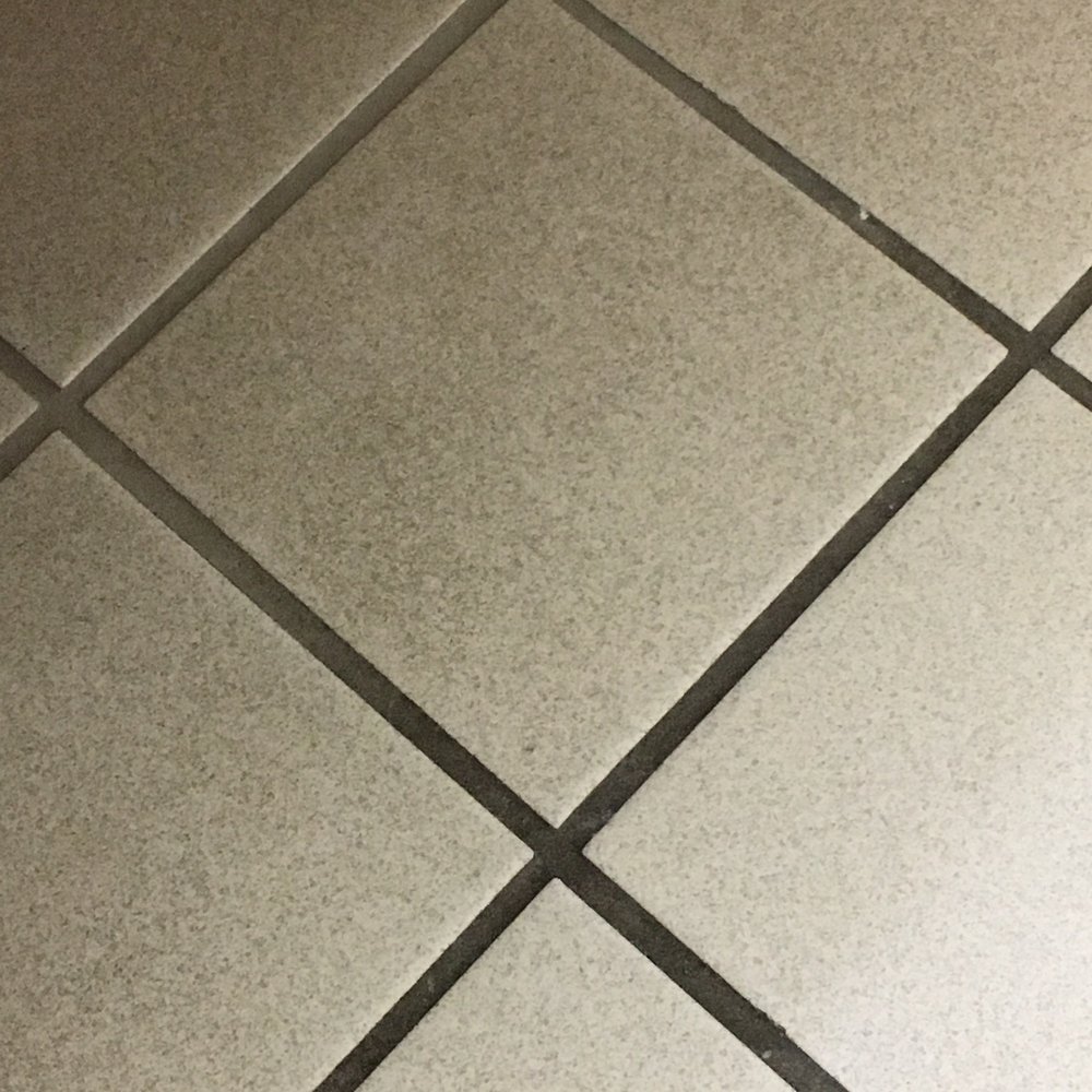 La Quinta by Wyndham Appleton College Avenue - Tile in bathroom.  Note the grout is clean under the sink but the main walking area is black. - Hotels Near Me - Appleton, Wisconsin
