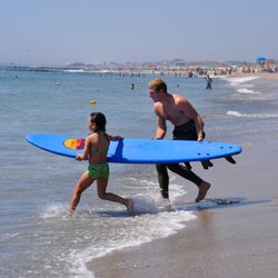 Summertime Surf School - Bradley Beach - Instructor Bryan brings a young student out for a few waves on a hot summer day.