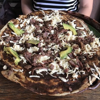 María y Su Bici - Tlayuda. Famous Oaxacan tortilla with mole, beans, fresh cheese, and avocado. This one had meat too. Diameter is 30 cm. - Oaxacan Near Me - Santiago de Querétaro, QUE María y Su Bici - Tlayuda. Famous Oaxacan tortilla with mole, beans, fresh cheese, and avocado. This one had meat too. Diameter is 30 cm. - Oaxacan Near Me - Santiago de Querétaro, QUE