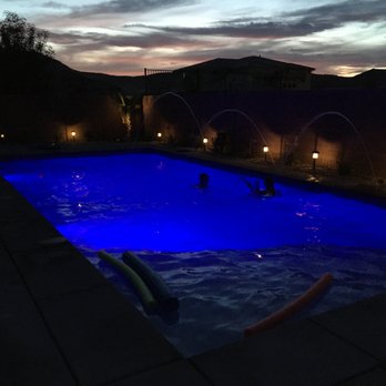 California Pools - Southern Utah - Pool at night with lighting and deck jets going. - Pool & Hot Tub Service Near Me California Pools - Southern Utah - Pool at night with lighting and deck jets going. - Pool & Hot Tub Service Near Me