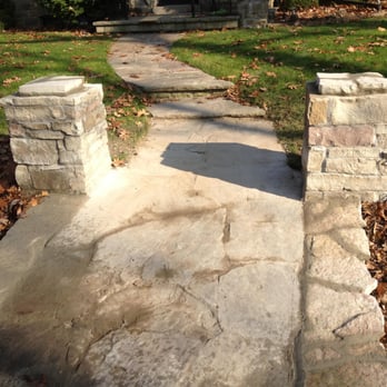 Elite Blue Gardens - a stone walkway leading to a house - Snow Removal Near Me Elite Blue Gardens - a stone walkway leading to a house - Snow Removal Near Me