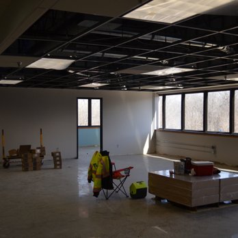 Rutledge Construction - a construction worker in a large room - General Contractors Near Me - Hopkins, Minnesota