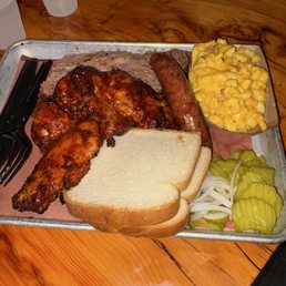 Our plate: chicken thigh, cheddar, sausage, brisket, Mac and cheese, free bread and pickles/onions Our plate: chicken thigh, cheddar, sausage, brisket, Mac and cheese, free bread and pickles/onions