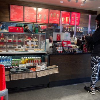 Starbucks - a woman standing in front of a counter - Coffee & Tea Near Me - Staten Island, New York
